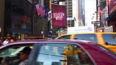 NEW YORK, USA, CIRCA MARCH 2015 : Shot of an intersection near Times Square in New York City showing passing cars and the M'Ms World in the background.