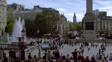 Yaklaşık Ekim 2011 - Londra, İngiltere: Shot in Trafalgar Meydanı Londra'da birçok kişi yürüyüş, featuring bir çeşme ve Lord Nelson'ın anıt dibinde. Sokak trafik, binalar, ağaçlar, bazı gökyüzü içinde belgili tanımlık geçmiş. Ekim, 2011 filme.