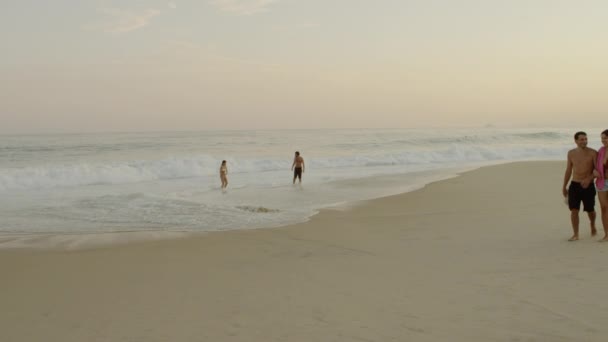 リオデジャネイロ 6月16 2013 イパネマビーチで2組のカップルのスローモーション静的ショット 一組のカップルが水を楽しんでおり もう1組は砂の上を歩いています ブラジル リオデジャネイロで撮影 — ストック動画