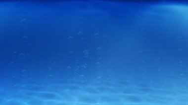 Güneş ışınları temiz su pierce gibi masmavi bir deniz, kumlu deniz dibinin kabarcıklar yükselişi.