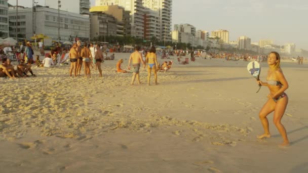 リオデジャネイロ ブラジル 2013年6月 スローモーション イパネマビーチでテニスをしている女の子のドリーアウトショット ボールを打つためにフレームからつまずく男と — ストック動画