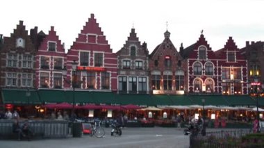 Pazar Meydanı (Markt), Bruges, Belçika yürüyüş insanların hızlandırılmış. Arka planda renkli, güzel binalar vardır.