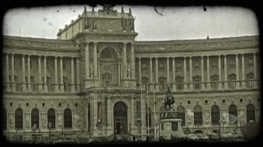 Savaş benzeri tutumunu tarihi, regal Hofburg Sarayı girişinin Viyana, Avusturya insanlarla ve araba binanın önünde bayrak taşıyan Süvari bronz heykeli.