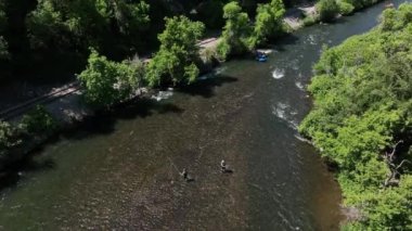 Aerial view of people fly fishing as raft floats down stream in Provo Canyon Utah.