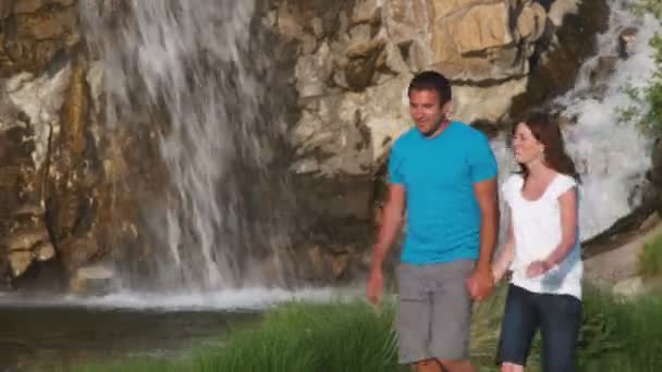 Medium Shot Couple Walking Garden Front Waterfall — Stock Video