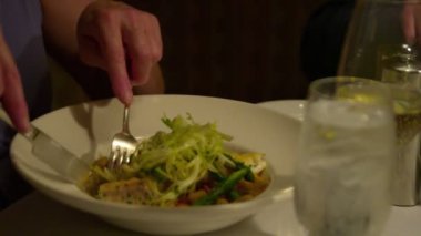 Sola doğru bir kapanışını kadar bir çiftin elinde zarif bir yer ayarı ile güzel bir yemek yerken kaydırma için