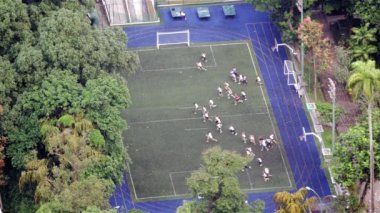 Rio de Janeiro, Brezilya futbol/futbol sahası arasında Sprint gençliğin büyük bir grup ağır çekim, yüksek-açı görüntüleri.