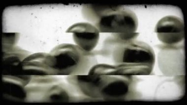 Bir avuç küçük siyah nesneleri görünümü ve rock biraz üzerinde rulo yuvarlak kenarlarına durdurma önce. Vintage stilize video klip.