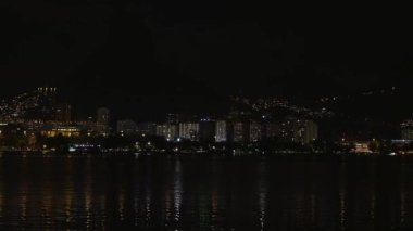 Waterfront ve kıyı, Rio de Janeiro şehrine statik bir kadeh. Binalar ışıklarını üzerine su yansıtan. Su biraz dalgaların. Corcovado hafifçe arka planda kontrast.