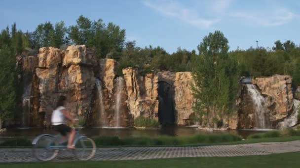 Una Giovane Donna Sella Alla Sua Moto Davanti Una Cascata — Video Stock