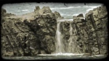 Hızlandırılmış bir İtalyan plajda kayalar üzerine çökmesini dalgalar bir atış. Vintage stilize video klip.