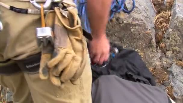 Shot Mountain Climber Packing His Pack Full Gear — Stock Video