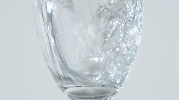 Close Stemmed Glass Being Filled Pouring Water White Background — Stock Video
