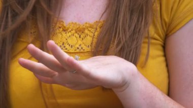 Genç bir adam güzel bir bahçe içinde genç bir kadın için öneriyor.