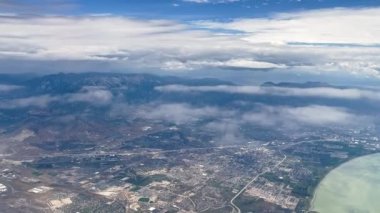 View from airplane flying over Lehi in Utah Valley viewing the cities and mountains spanning the landscape.