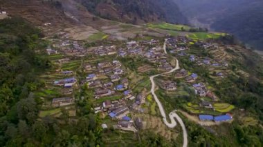 Aerial view of houses on the mountainside in Nepal and terraces near Pokhara.