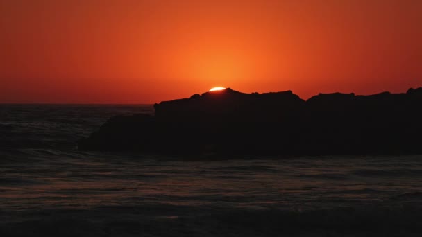 Солнце Окунается Скалами Пляже Закате Небо Светит Яркими Красками — стоковое видео