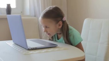 Küçük tatlı kız video oyunu, eğitim ya da oyun oynamak için dizüstü bilgisayar kullanıyor..