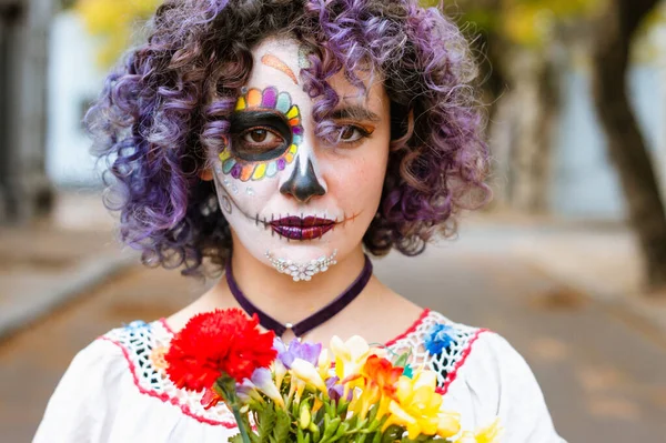 front view portrait of young latin caucasian argentinian woman, standing outdoors in the cemetery with 