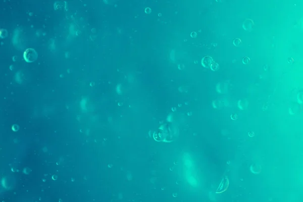 Textura de gel antiséptico transparente de menta con burbujas de aire sobre fondo monocromo azul claro — Foto de Stock