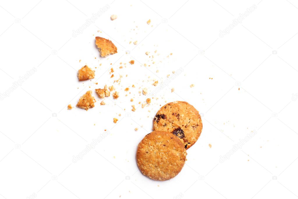 Scattered crumbs of vanilla chip butter cookies isolated on white background. Close-up view