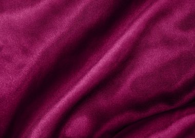 Zarif mor ipek ya da saten kıvrımlar. Kumaş dokusu arka planı. Soyut duvar kağıdı