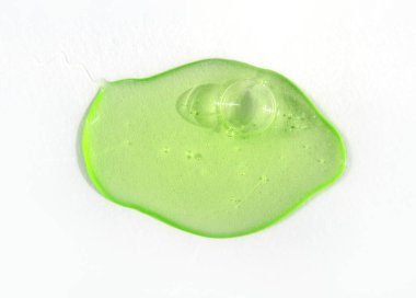 Drop of green fluid hyaluronic acid on white background. Cosmetics and healthcare concept closeup clipart