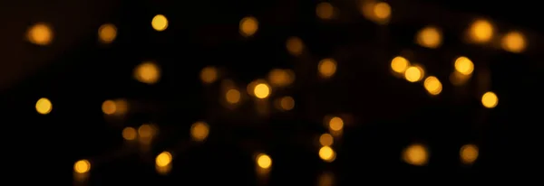 Banner of Defocused bokeh lights on black background, an abstract naturally blurred backdrop — Fotografia de Stock