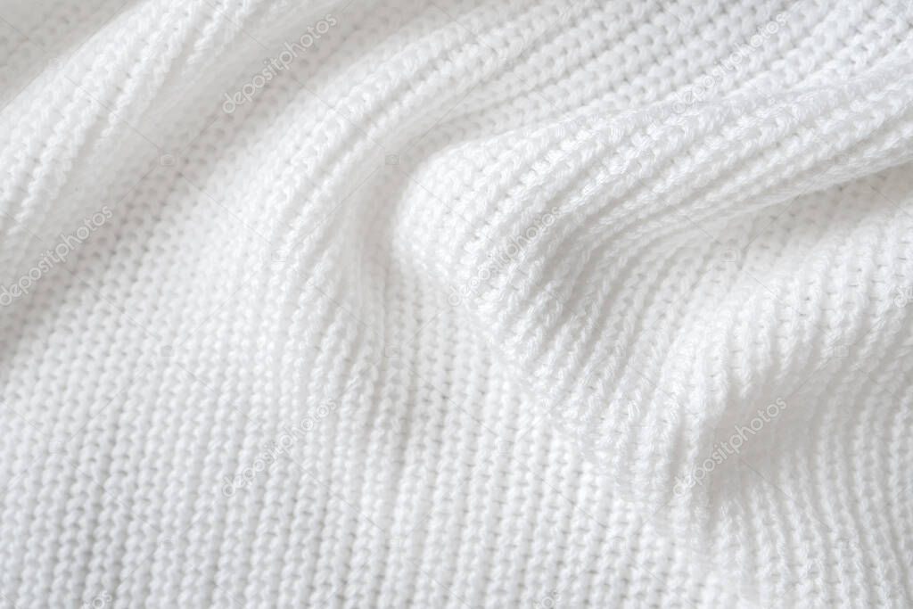 Soft knitted sweater texture closeup. Light abstract background