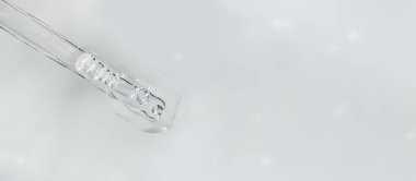 Tek renkli gri arka planda sıvı hyaluronik asitli Pipette sancağını. Kozmetik ve sağlık konsepti yakın plan