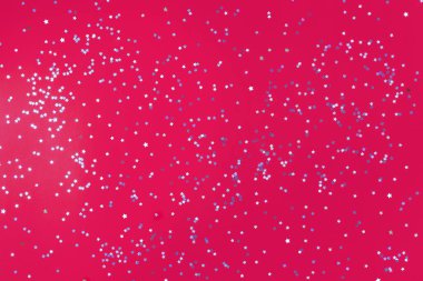 Bir sürü gümüş yıldızlı şenlikli pembe arka plan. Noel, Yeni Yıl veya Doğum günü teması