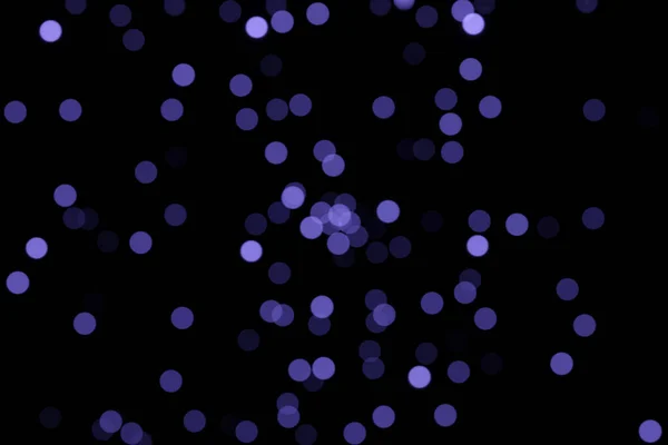 Defocused bokeh lights on black background, an abstract naturally blurred backdrop. Color 2022 — Stockfoto