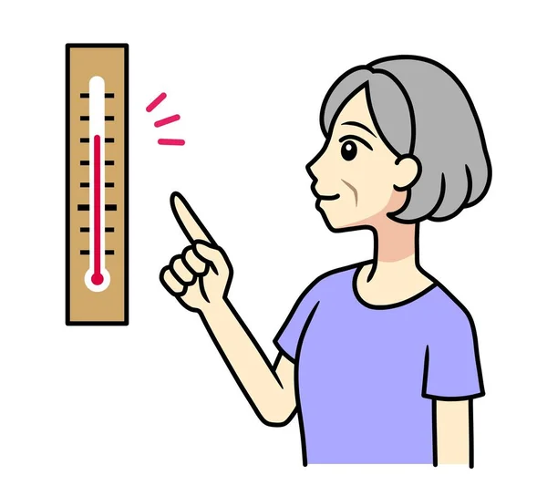 A senior woman checking a temperature with a thermometer