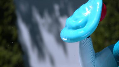 Su dolu mavi bir top, genç bir adamın tekmesiyle dümdüz oldu.