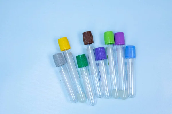 Vacuum tubes for collection and blood samples on blue background with sodium citrate EDTA heparin fluoride anticoagulant for laboratory