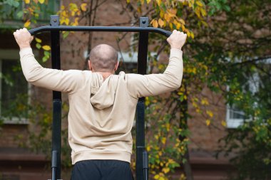 Şehrin açık alanlarında bir adam spor için içeri girer.