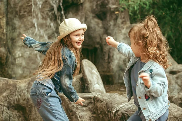 아이들은 따뜻 한 계절에 공원에서 활발하고 유쾌하게 산책하며 시간을 보냅니다. — 스톡 사진