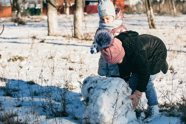 Farklı yaşlarda iki kız eğleniyor ve aktif olarak kış yürüyüşüne çıkıyorlar.