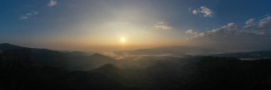 panoramic aerial landscape view morning sunlight blue sky and mountain range with fog in valley at chiang rai Thailand, panorama for webpage background concept 