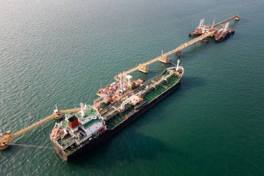 oil tank ship loading and unloading oil and gasoline at Commercial dock in sea business Services Transportation Worldwide ocean freight at evening  photograph aerial top view from drone