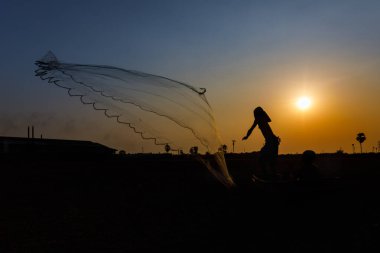 aksiyon balıkçısı silueti gün doğumunda mavi gökyüzü altın arkaplanı