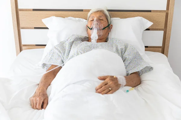 stock image asia elderly patient sleeping on oxygen and saline solution in hospital room Thailand