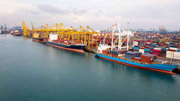 Container ship at industrial port in import export global business services logistic and transportation, Container ship loading and unloading freight shipment by cranes , Aerial view