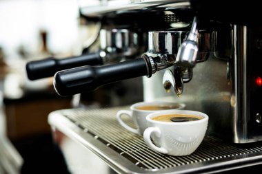Kahve makinesi espressoları beyaz bardakta.