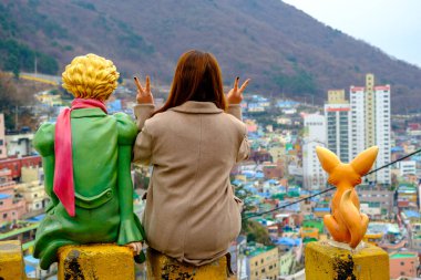 Busan city, South Korea - December 29, 2019: People photo with Little Prince statues in Gamcheon Culture Village Busan city of South Korea clipart