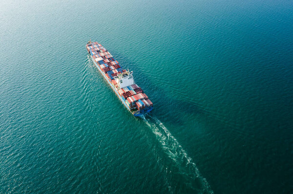 Container ship full load carrying for import and export, business cargo logistic and transportation by container ship in open sea, photograph from drone camera aerial view Transportation concept,  
