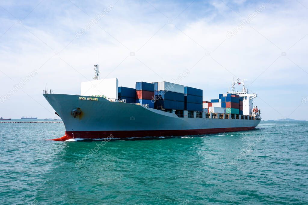 container cargo ship carrying commercial container in import export business services commerce logistic and transportation of international and worldwide by container ship open sea, drone of Point view in front 