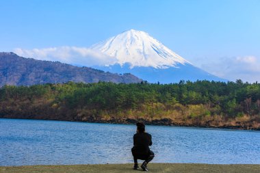 fuji mountain and river forest foreground and travel tourist take photo by smartphone in Japan 