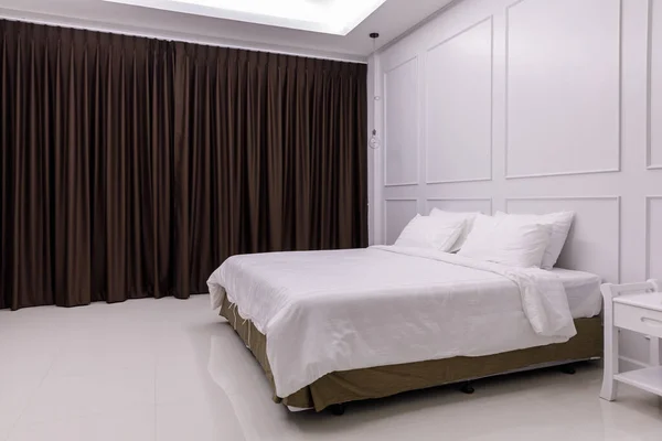 white bed in the white bedroom brown curtain