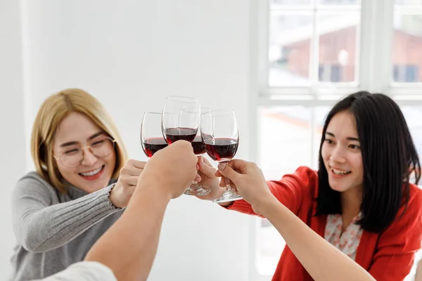 young asian people cheering red wine enjoy party in office, business people party celebration success Concept